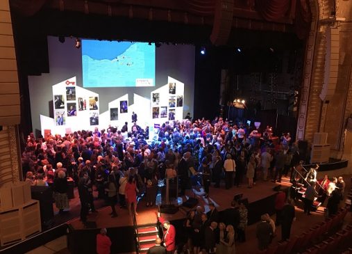 crowd pictured onstage at 2018 annual meeting community reception